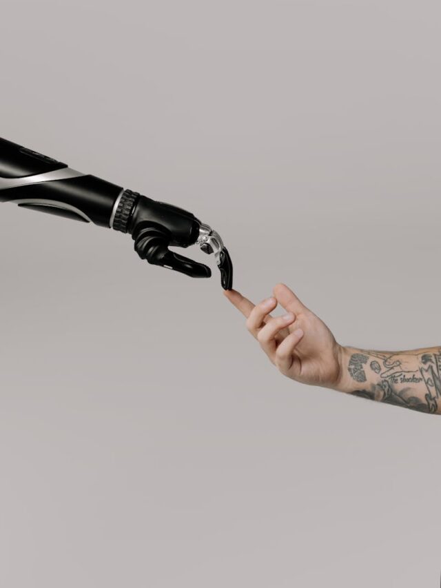Close-up of a prosthetic arm and a human hand reaching towards each other in harmony.